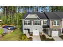 Aerial view of a gray two-story home with one-car garage and manicured lawn at 501 Hazy Hills Ln, Garner, NC 27529