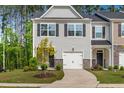 Inviting gray two-story home featuring a one-car garage and fresh landscaping at 501 Hazy Hills Ln, Garner, NC 27529