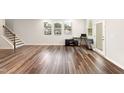 Spacious living room with wood floors, lots of natural light, and stairs to the second floor at 501 Hazy Hills Ln, Garner, NC 27529