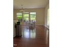 Bright dining area with hardwood floors, three windows and a modern chandelier at 525 Abbey Fields Loop, Morrisville, NC 27560