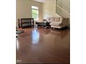 Bright living room with hardwood floors, sectional sofa, and a window for natural light at 525 Abbey Fields Loop, Morrisville, NC 27560