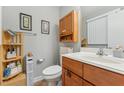 Cozy bathroom with wooden fixtures, vanity, and storage shelves, providing functionality and a clean design at 5932 Johnson Pond Rd, Fuquay Varina, NC 27526