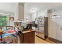 Bright eat-in kitchen featuring stainless steel appliances, wood floors and ample counter space, ideal for cooking at 5932 Johnson Pond Rd, Fuquay Varina, NC 27526