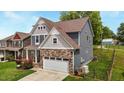 Beautiful two-story home with stone accents, two-car garage, and well-maintained landscaping at 635 Black Angus Dr, Haw River, NC 27258