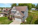 Beautiful two-story home with stone accents, two-car garage, and well-maintained landscaping at 635 Black Angus Dr, Haw River, NC 27258