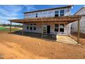 New home with a large covered patio and visible framing at 682 Old Station Pointe, Angier, NC 27501