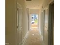 Hallway featuring clean lines, neutral paint, and an entry view showcasing the natural light and front yard at 682 Old Station Pointe, Angier, NC 27501