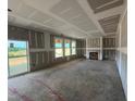 Spacious living room with three windows and a fireplace, awaiting final touches at 682 Old Station Pointe, Angier, NC 27501
