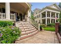 Spacious front porch with ornate staircase and columns, leading to an elegant home at 8308 Society Pl, Raleigh, NC 27615