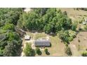 Sprawling acreage featuring home, a detached garage and garden area all surrounded by mature trees at 921 Sweet Raspberry Lane Ln, Lillington, NC 27546