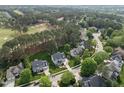 Gorgeous aerial view of a home nestled in a golf course community with lush trees at 925 Hidden Jewel Ln, Wake Forest, NC 27587