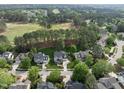 Aerial view of a home nestled in a golf course community with mature trees at 925 Hidden Jewel Ln, Wake Forest, NC 27587