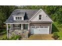 Charming home featuring stone accents, a covered front porch, and an attached two-car garage at 96 Linda Lou Ln, Angier, NC 27501