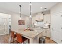 Updated kitchen featuring an island with granite countertops, pendant lighting, and stainless steel appliances at 1008 Sounding Ln, Durham, NC 27703