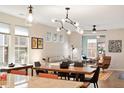 Open floor plan with a rustic wooden dining table, a pendant light fixture, and modern decor at 1008 Sounding Ln, Durham, NC 27703