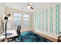 Bright home office with hardwood floors, stylish blue rug, ceiling fan, and a large window at 1008 Sounding Ln, Durham, NC 27703