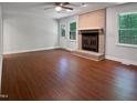 Spacious living room features wood floors and a brick fireplace at 1104 Theresa Ct, Raleigh, NC 27615