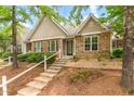 Charming townhouse with stone and brick accents, manicured landscaping, and a welcoming entrance amidst mature trees at 11220 Avocet Ln # 104, Raleigh, NC 27617