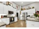 Bright kitchen features stainless appliances, granite counters, and ample cabinet space at 115 Thornwhistle Pl, Garner, NC 27529
