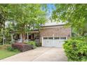 Charming brick home featuring a well-manicured lawn and a welcoming front porch with a two-car garage at 12212 Ashton Woods Ln, Raleigh, NC 27614