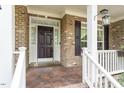 Inviting front porch showcasing decorative columns, detailed door frame, and classic design at 12212 Ashton Woods Ln, Raleigh, NC 27614