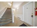 Well-lit hallway with stairs and access to unit 103 at 1301 Durlain Dr # 103, Raleigh, NC 27614
