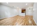 Open-concept living area with wood floors and a view into the kitchen at 1301 Durlain Dr # 103, Raleigh, NC 27614