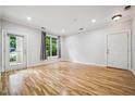 Spacious living room with wood floors, bright windows, and neutral walls at 1301 Durlain Dr # 103, Raleigh, NC 27614