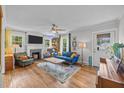 Cozy living room featuring hardwood floors, fireplace, TV, and bright natural light at 1541 Shadylawn Dr, Burlington, NC 27215