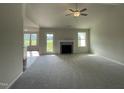 Spacious living room with a fireplace, large windows, and an open floor plan at 180 Tulipfield Way, Benson, NC 27504