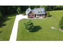Expansive aerial view of the property showcasing a beautiful home, long driveway and large grassy areas at 200 Daniel Ridge Ln, Roxboro, NC 27574