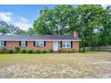 Charming single-story brick home featuring a cozy front yard and traditional curb appeal at 202 Hamilton Rd, Bunnlevel, NC 28323