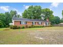 Charming single-story brick home with manicured bushes, located on a spacious and green lot at 202 Hamilton Rd, Bunnlevel, NC 28323