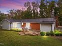 Private backyard features a stone patio, a built-in grill and an inviting fire pit perfect for entertaining at 203 W Boundary St, Cary, NC 27513
