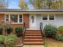 Welcoming front entrance with brick steps, a decorative door wreath, and fresh landscaping details at 203 W Boundary St, Cary, NC 27513