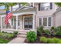 Inviting front porch with rocking chairs, double doors adorned with wreaths, and beautiful landscaping at 205 Slate Blue Pl, Cary, NC 27519