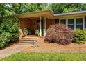 Inviting brick front porch with steps, decorative plants, and stylish accents, creating a warm entrance at 2053 Nottingham Ln, Burlington, NC 27215
