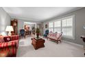 Bright living room offers ample seating, large windows, and seamless transition to the dining area at 2053 Nottingham Ln, Burlington, NC 27215