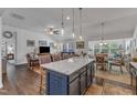 Open concept kitchen island with granite countertop and bar seating overlooking the living area at 2634 Yellow Pine Rd, Raleigh, NC 27616