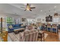 Bright living room with a blue sofa, patterned rug, and view into the kitchen at 2634 Yellow Pine Rd, Raleigh, NC 27616
