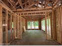 The interior wood framing of a house with window views of the outdoors at 275 Atkins Rd, Cameron, NC 28326