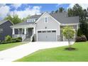 Beautiful home with a two-car garage, stone accents, well-manicured lawn, and a welcoming front porch at 309 Hines Point Dr, Rolesville, NC 27571