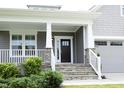 Inviting front porch with stone steps, white railings, and a stylish front door perfect for relaxing at 309 Hines Point Dr, Rolesville, NC 27571