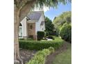 A charming view of the exterior showcasing manicured landscaping, brick accents, and a well-maintained lawn at 3129 Elm Tree Ln, Raleigh, NC 27614