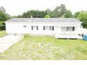 This exterior view shows a white single story home with black shutters and a charming front porch at 3354 Altamahaw Church Rd, Elon, NC 27244