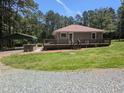 Inviting exterior view with expansive yard, covered parking, and classic ranch-style home at 3405 Ode Turner Rd, Hillsborough, NC 27278