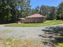 Single-level home showcases a long driveway, covered parking, and a large, private lot at 3405 Ode Turner Rd, Hillsborough, NC 27278