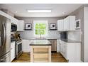 Bright kitchen features white cabinets, stainless steel appliances, granite countertops, and center island at 3906 Union Ridge Rd, Burlington, NC 27217