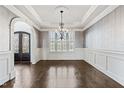 Formal dining room featuring decorative ceiling, hardwood floors, and large windows at 3908 Chaumont Dr, Apex, NC 27539