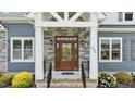 Detailed front door with stone accents and decorative wreath, enhancing the home's entry appeal at 4564 Ashton'S Way, Franklinton, NC 27525